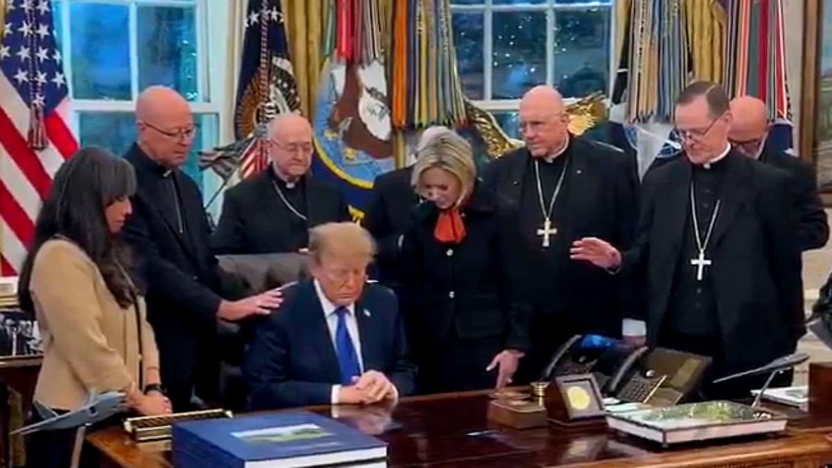 President Donald Trump and Catholic leaders pray in the Oval Office