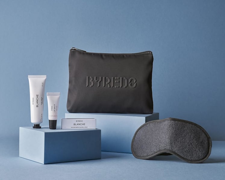 Business class passengers will enjoy a Byredo amenity kit, featuring a soft grey zip pouch and, from left, the brand’s Blanche Hand Cream, lip balm, and Blanche Eau de Parfum, alongside eye shades and a dental kit. (Photo: Singapore Airlines)