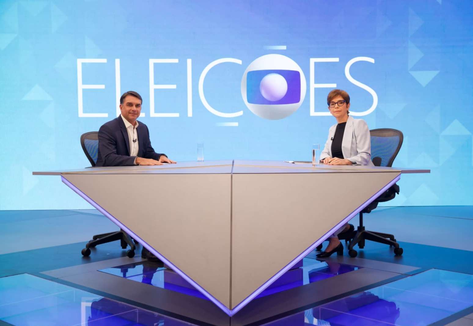 Flávio Bolsonaro e Renata Lo Prete em sabatina da Globo nesta sexta-feira, 16
