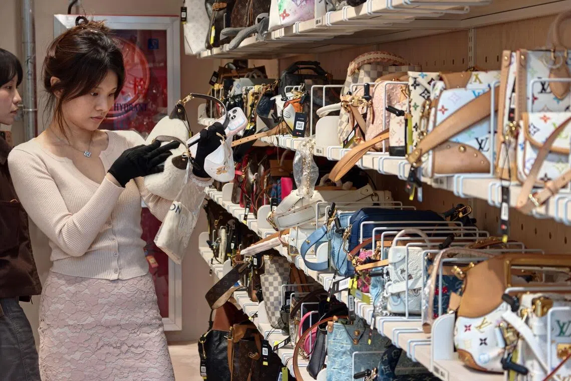 A customer browsing purses among second-hand luxury goods at the Zhuanzhuan superstore in Shanghai on Oct 14.